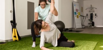 physiotherapist-assisting-young-caucasian-woman-with-exercise-with-dumbbell_1139-1246.jpg